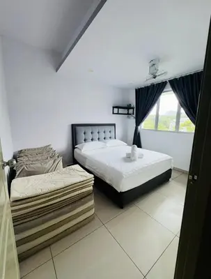 a bedroom with two beds and a window at AYAAN PENTHOUSE at QUINTET ROOFTOP BBQ AND DINING with Mini Snookers in Tanah Rata