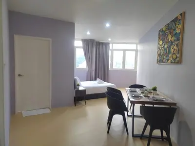 a room with a table and chairs and a bed at Spacious 1BR 118 Island Plaza 4pax in George Town