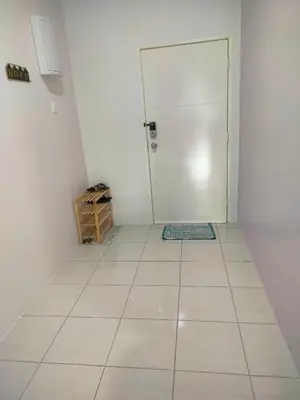a white room with a door and a tile floor at VS Homestay in Ipoh