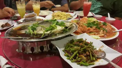 a red table with plates of food on it at Ipoh Town, Anderson Residence in Ipoh