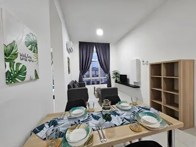 a dining room table with plates and glasses on it at Ipoh Town, Anderson Residence in Ipoh