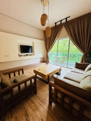 a living room with a couch and a table at AYAAN QUINTET Green Valley with Free Parking in Tanah Rata