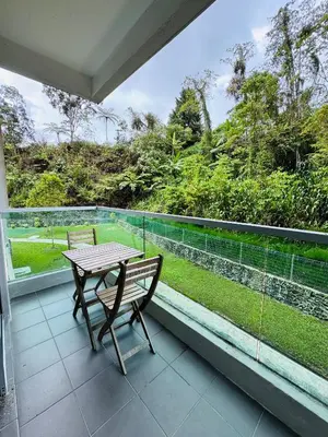 a balcony with a wooden table and a bench on it at AYAAN QUINTET Green Valley with Free Parking in Tanah Rata