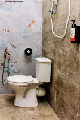 a bathroom with a toilet and a shower at 13-Pax Vacation Retreats in Butterworth near Sunway Carnival in Perai