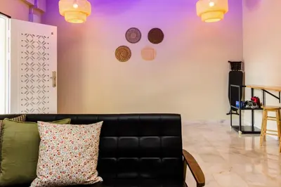 a living room with a couch and a purple wall at 13-Pax Vacation Retreats in Butterworth near Sunway Carnival in Perai
