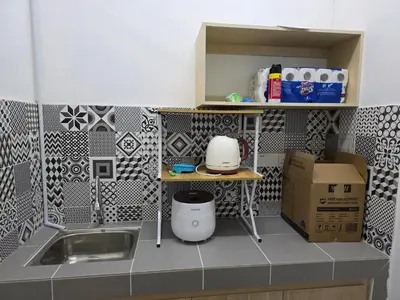 a small kitchen with a sink and a counter top at Aqimi Homestay in Seri Iskandar
