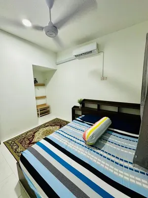 a bedroom with a bed with a pillow on it at Cozy All Four Bedroom with Aircond Stay wifi and Netflix in Kampong Bota Road