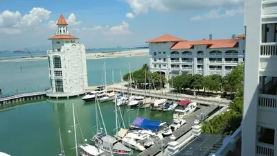 a marina with boats in the water next to buildings at Dreame Home by The Quay in George Town