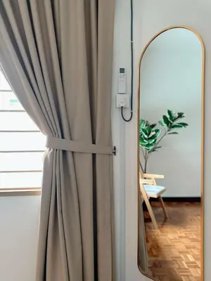 a room with a curtain and a mirror at W Home at Jalan Rangoon, George Town Penang in George Town