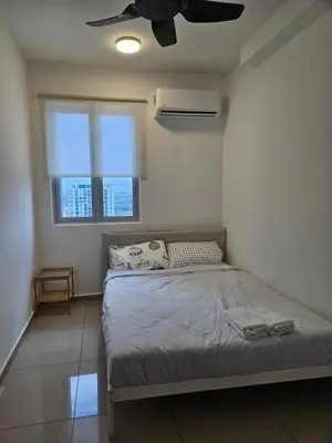 a bedroom with a bed with a ceiling fan at New Metropol 3 Bedrooms Pool View in Bukit Mertajam