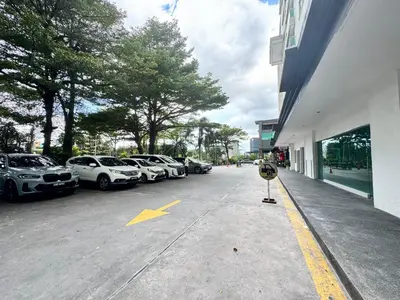 a parking lot with cars parked next to a building at Kinta River Town Suites By IWH in Ipoh