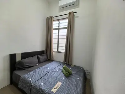 a bed in a room with a window at Suite Karangan Near Inokom in Titi Karangan