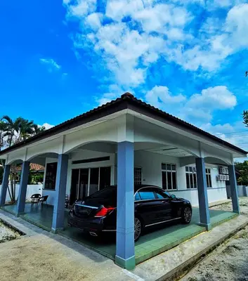 a car parked in front of a house at Venice Manjung, Lumut by TZ Homestay in Lumut