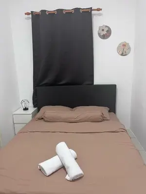 a bed with two towels on top of it at CT Hillcrest Loft Ipoh in Ipoh