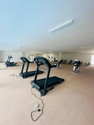 a gym with several tread machines in a room at CT Hillcrest Loft Ipoh in Ipoh
