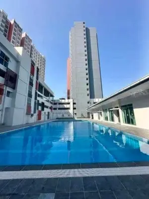 a large swimming pool in a city with tall buildings at CT Hillcrest Loft Ipoh in Ipoh