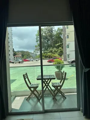 a patio with a table and two chairs in front of a window at AYAAN GAMING HOME at Quintet Play Free GranTurismo in Tanah Rata