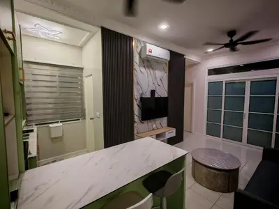 a kitchen with a table and a tv in a room at Arrisa Guest House d'Anderson Ipoh Perak in Kampong Kepayang