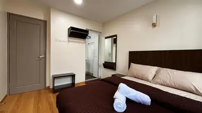 a bedroom with a bed with two white pillows on it at Skye Apartment Hotel in Brinchang