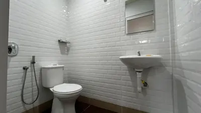 a bathroom with a toilet and a sink at Skye Apartment Hotel in Brinchang