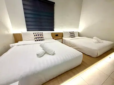 a bedroom with two beds and a window at LYL EvenHill Private Pool-18-23pax 5BR in Ipoh