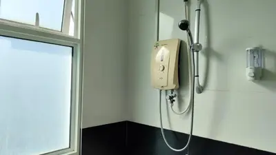 a shower in a bathroom with a soap dispenser on the wall at High-Rise Suite with view-Near Gurney & Gleneagles in George Town