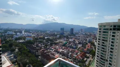 an aerial view of a city with buildings and mountains at High-Rise Suite with view-Near Gurney & Gleneagles in George Town