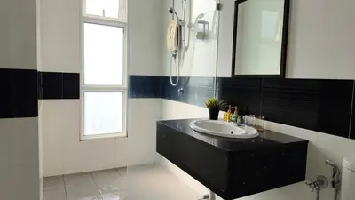 a black and white bathroom with a sink and a mirror at High-Rise Suite with view-Near Gurney & Gleneagles in George Town