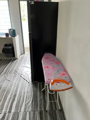 a chair sitting in a room next to a door at CK Homestay Parit Buntar Perak in Bagan Serai