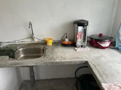 a kitchen counter with a sink and a coffee maker at CK Homestay Parit Buntar Perak in Bagan Serai