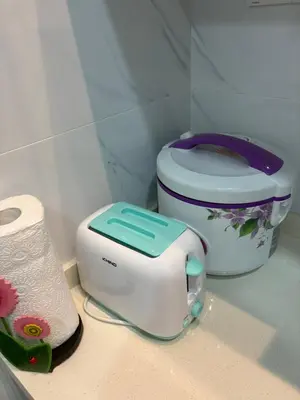 a toaster sitting on a counter next to a toilet at HoMestaY Kulim Seri Rambai in Kulim