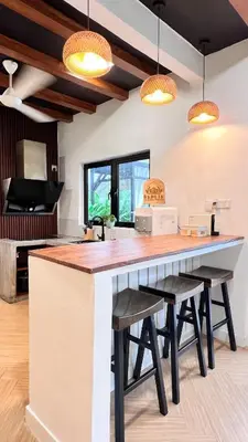 a large kitchen with a large counter and stools at Dahlia Kulim Pool Homestay in Kulim