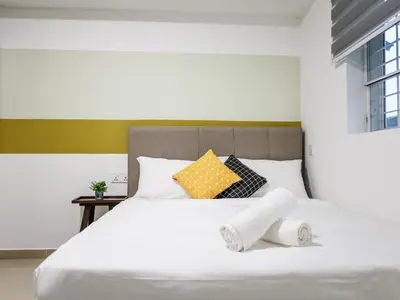 a bedroom with a white bed with towels on it at Wishful Guesthouse at Georgetown#LohGuanLye#BudgetStay in George Town