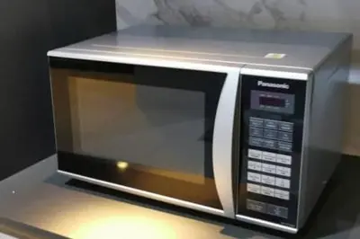 a microwave oven sitting on top of a counter at Cozy Seaview Duplex Apartment at Sunrise Gurney in George Town