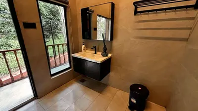 a bathroom with a sink and a mirror at Charming Nature Kampung Home for Family Getaways in Benta