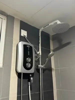 a shower in a bathroom with a hair dryer at High Floor Naz Comfort Suite Champs Elysees in Kampar