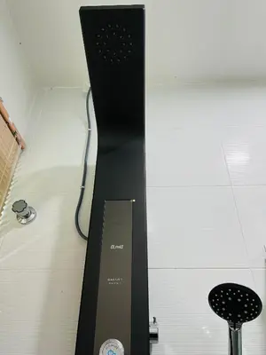 a black stand with a clock next to a stool at Sofea Homestay Ipoh V2 in Ipoh
