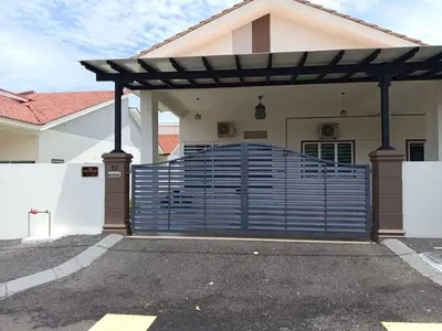 a blue gate in front of a white house at Iman4 Homestay in Kampung Behrang