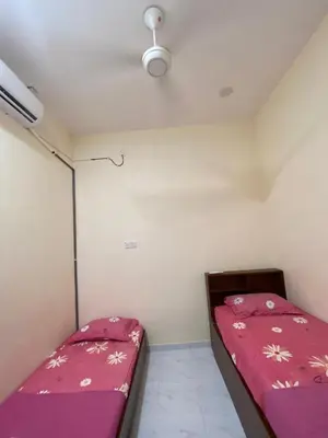 a small room with two beds in it at Nabilah Homestay Labuh Banting in Kepala Batas