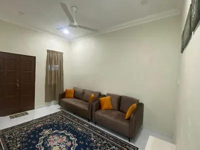 a living room with a couch and a rug at Nabilah Homestay Labuh Banting in Kepala Batas