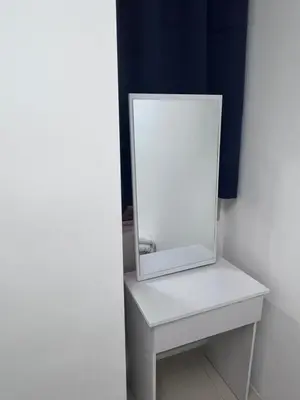 a mirror sitting on top of a white table at AYAAN COZY PRIMA HOMESTAY FREE WiFi in Tanah Rata