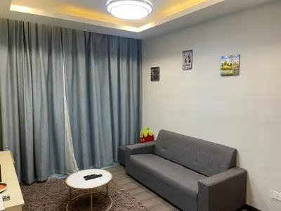 a living room with a couch and a table at AYAAN COMFY PRIMA HOMESTAY FREE WiFi in Tanah Rata