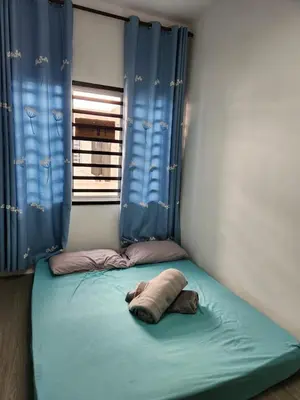 a small bed in a room with a window at AYAAN COMFY PRIMA HOMESTAY FREE WiFi in Tanah Rata
