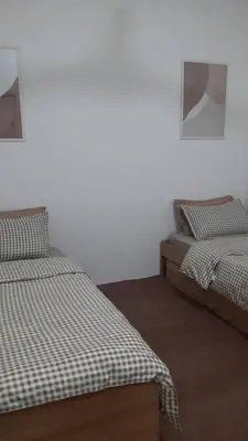 two beds sitting next to each other in a room at The SAFYYA House Teluk Senangin in Lumut