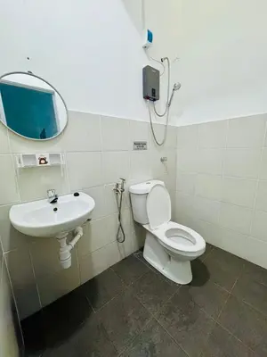 a bathroom with a toilet and a sink at Zalins CozyHome 3BR - Double Storey Terrace in Kepala Batas