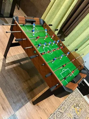a wooden table with a game of snooker at AYAAN PLATINUM Foosball Home at Quintet Apartment Free Parking in Tanah Rata