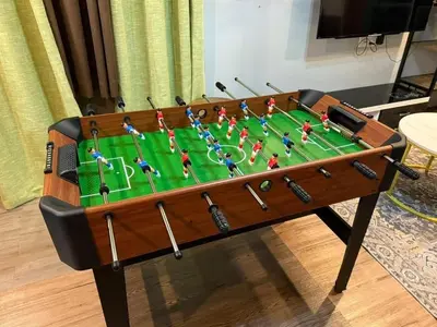a table with a chessboard on top at AYAAN PLATINUM Foosball Home at Quintet Apartment Free Parking in Tanah Rata