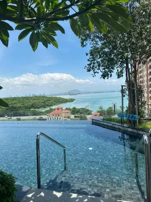 a swimming pool with a view of the water at Georgetown Ins Cozy Suites 2BR in George Town