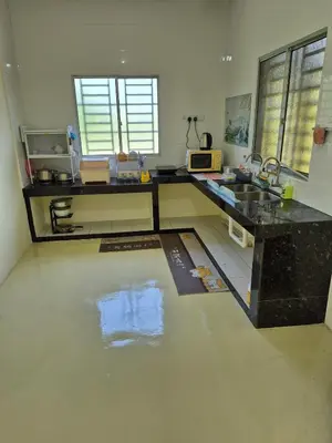 a kitchen with a sink and a counter top at Vacation Ipoh Homestay for 12 Pax 4 Bedrooms for Delicious Food in Ipoh
