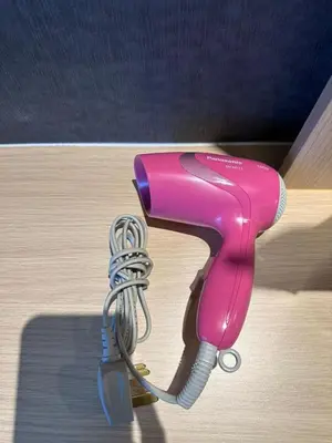 a pink hairdryer with a wire attached to it at Adik Aisyah cameron semi-D goleden hill homestay in Brinchang